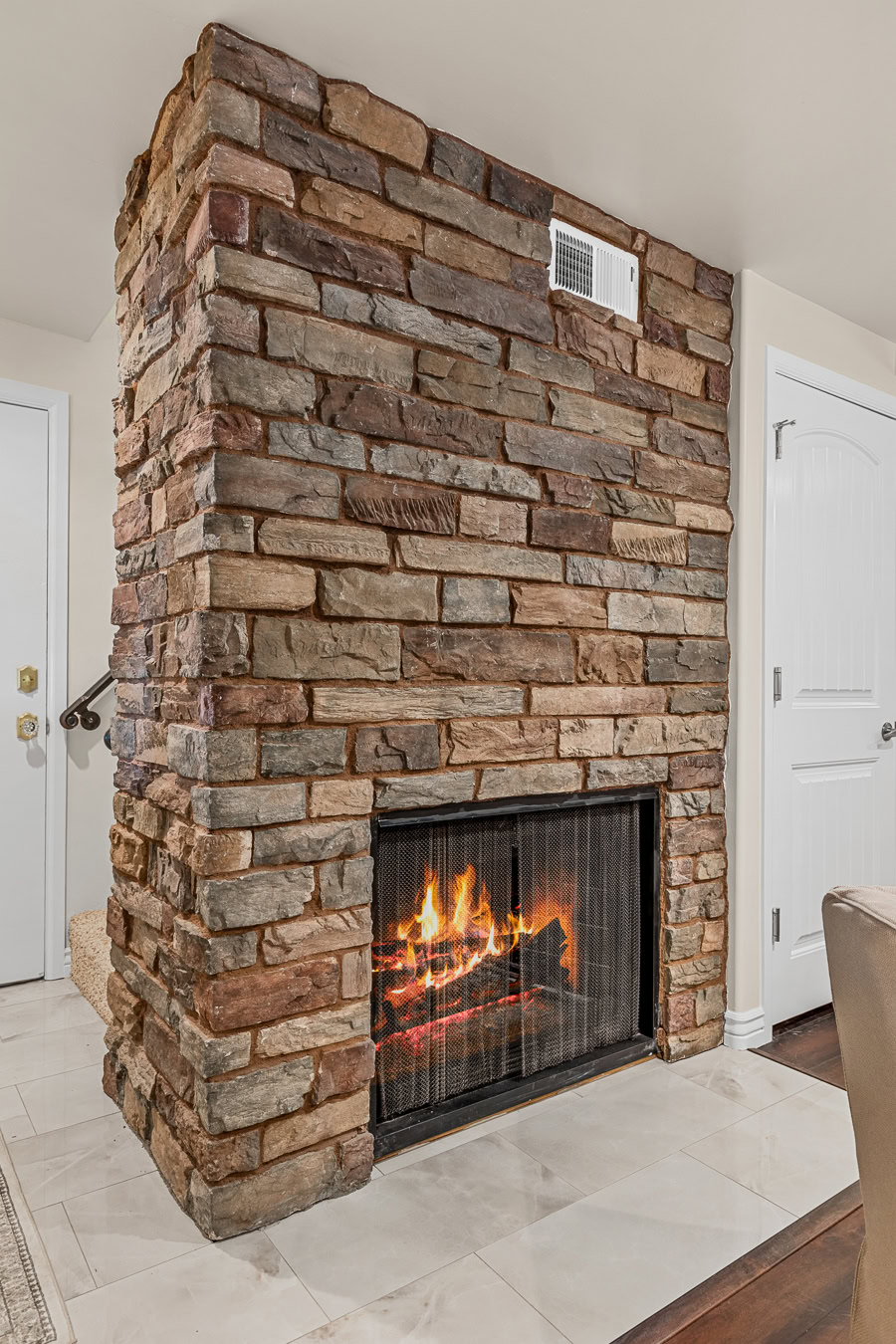 beautiful fireplace with a warm colored stone finishing