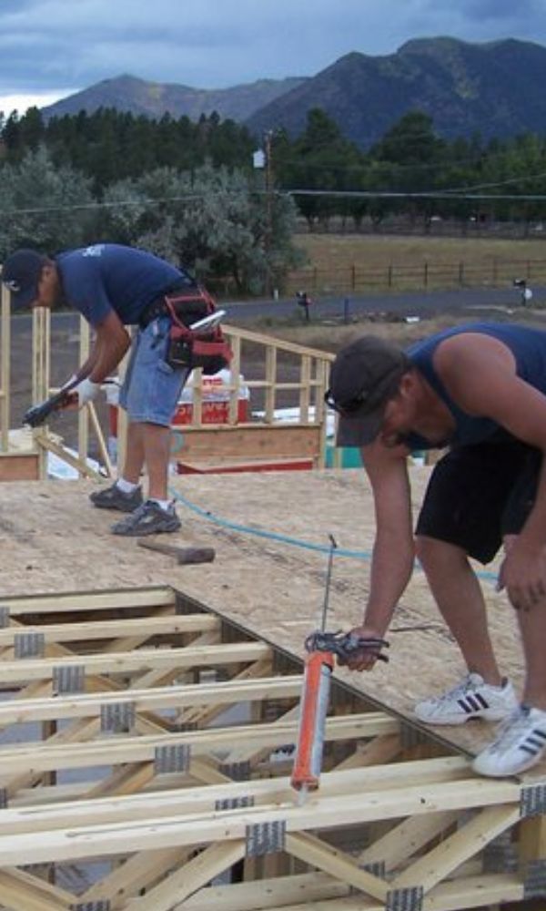 Construction Workers Glueing Together Framework
