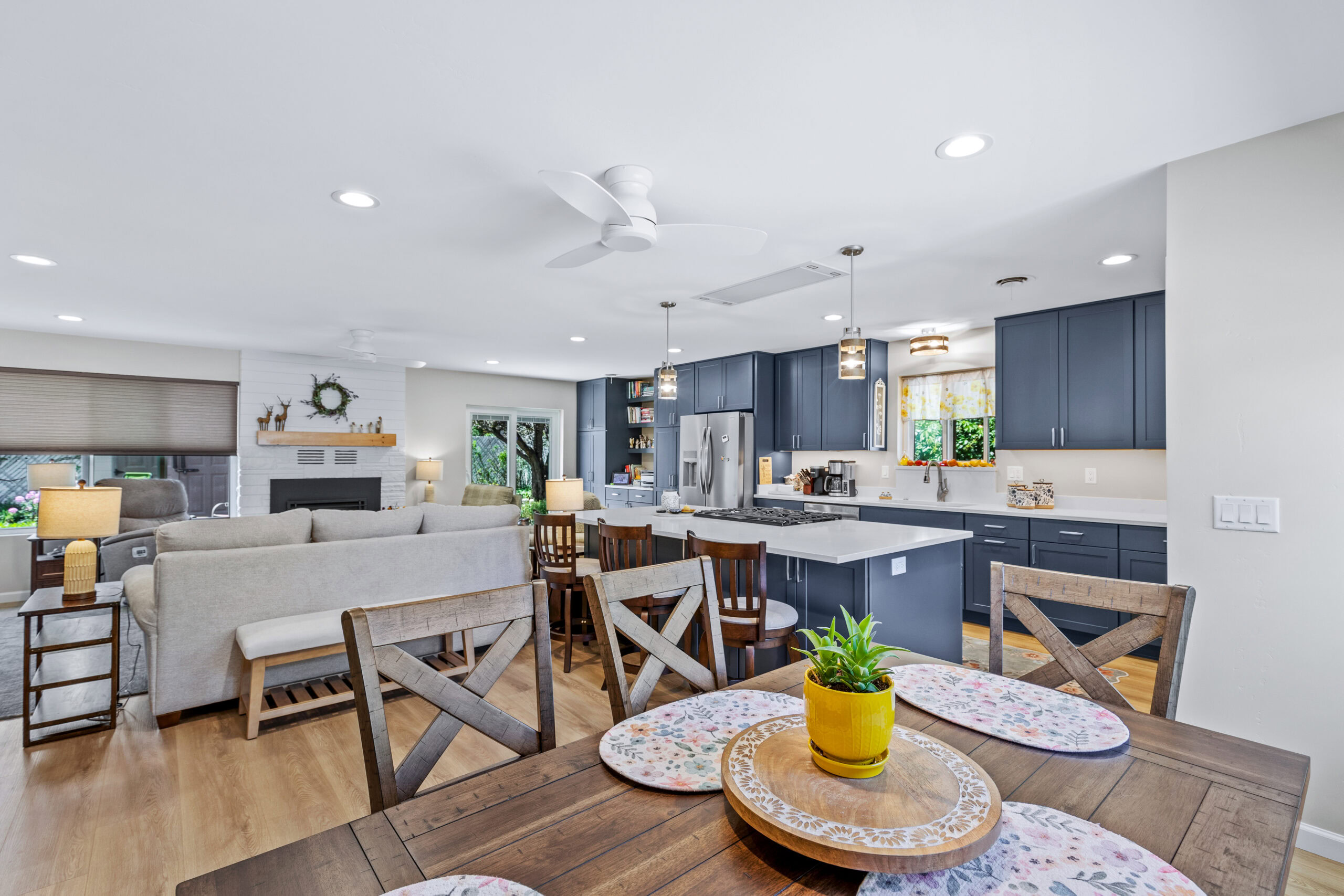 Wayman interior remodel with blue kitchen cabinets and an open living and dining area